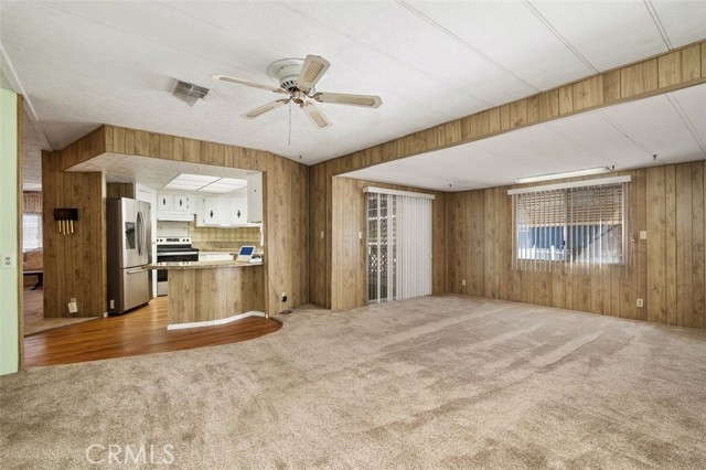 Family Room is spacious layout accented by hardwood paneling giving the room a cozy atmosphere. Sliding Door opens to the large front porch area.