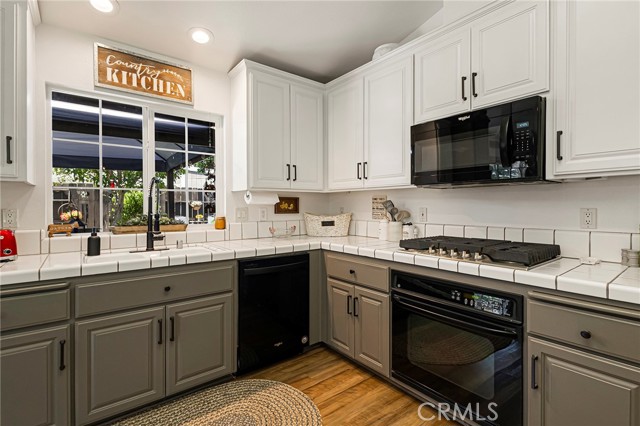 Updated gas cooktop, cabinet handles, + designer paint!