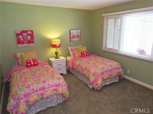 This sizable bedroom has beautiful base molding and a sizeable window looking out to the pool yard This sizable bedroom has beautiful base molding and a sizeable window looking out to the pool yard