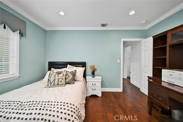 Downstairs Bedroom with a walk-in Closet with a custom closet organizer