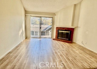 Living room with fireplace, patio door, high ceiling
