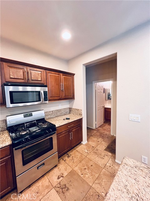 back of kitchen leads to downstairs bedroom, full bath, laundry room and 3 car garage