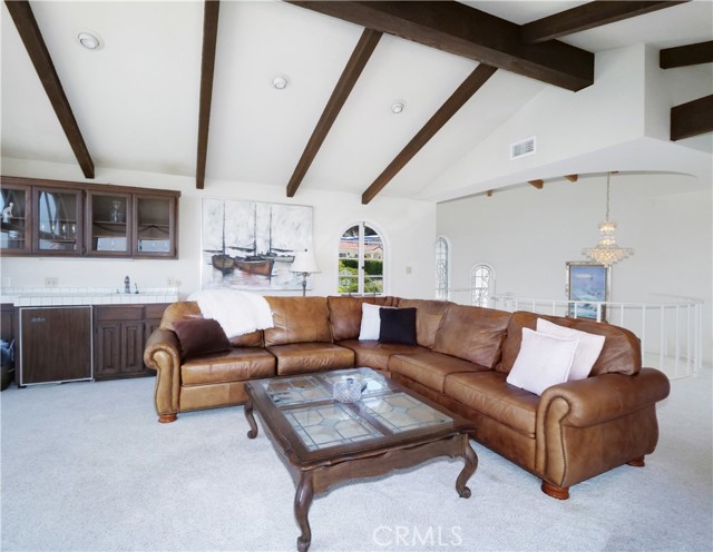 Upstairs Family Room with wet bar, sink and built in glass cabinets