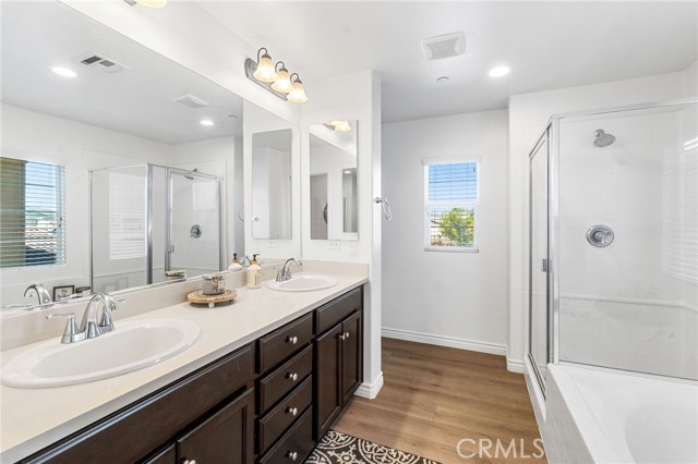 Large primary bathroom with double sink vanity, separate shower and soaking tub.