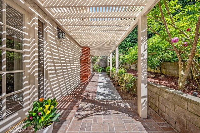 The expansive Pergola and patio extends along the entire backside at the Main level of this home.