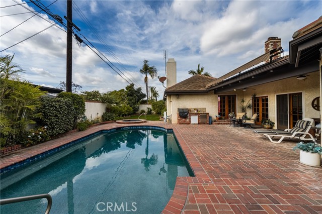 Expansive Backyard with Sparkling Pool and Outdoor Entertaining Area