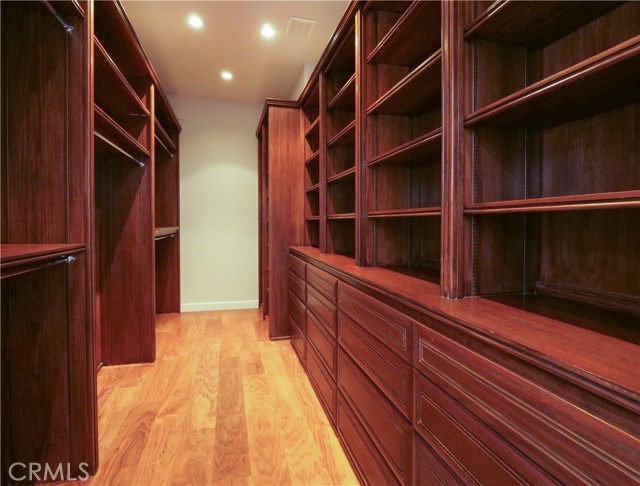 Large walk-in closet with built-in drawers and shelving