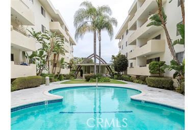 Sparkling pool with clubhouse in center courtyard