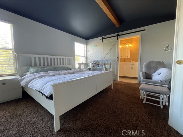 Main bedroom has custom paint colors and an open beam accent