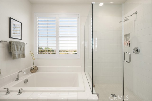 Bright Spa Retreat with Soaking Tub and Glass-Enclosed Shower