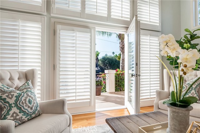 French doors lead to a bright and sunny deck off the living room