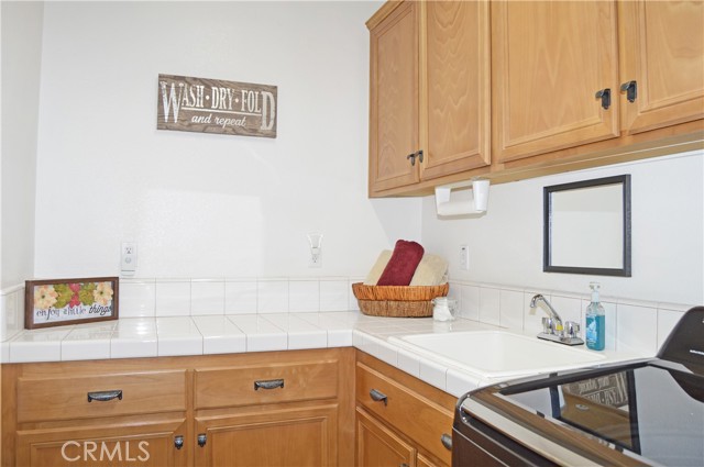 Laundry/Utility Room with BRAND NEW Washer & Dryer, Plenty of Cabinet/Counter Space and a Handy Sink
