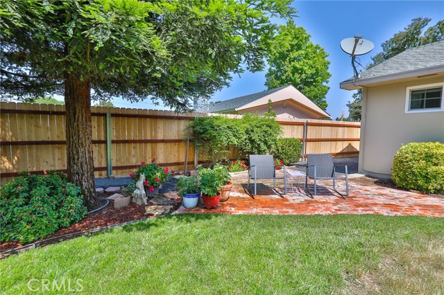 Big trees on this side provide plenty of shade over a pretty bricked area.