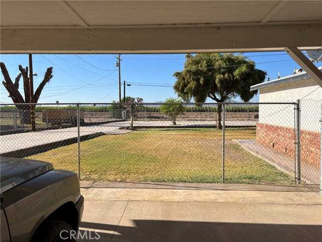 View from Carport.Very spacious Backyard with  generous amounts of concrete!