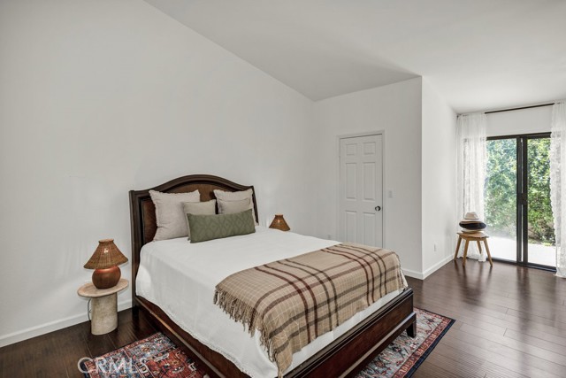 View of the primary suite as seen from the hallway.  Walk-in closet is located at the Left.  The slider doors lead to the private rear yard.