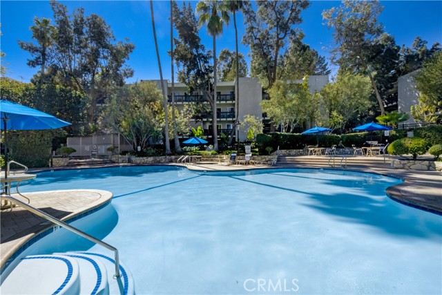 Sparkling large pool and pool deck is great for entertaining with it's BBQ and jacuzzi and direct access to the community room!