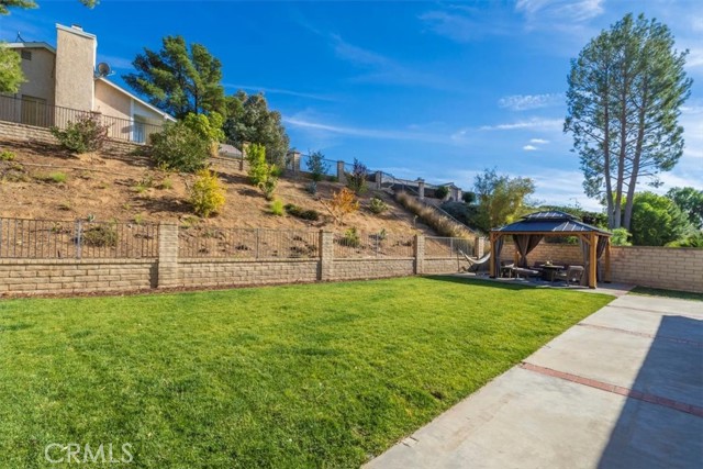 Back yard goes beyond retaining wall.