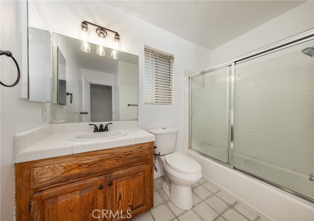 Guest Bathroom with Tile Flooring Shower over Tub