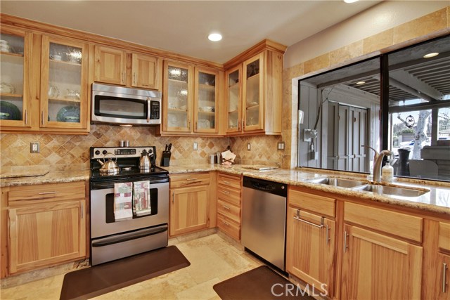 Designer backsplash and kitchen window to the patio and outdoors