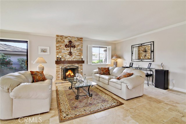 Open living area with an abundance of light. Travertine flooring and crown moldings