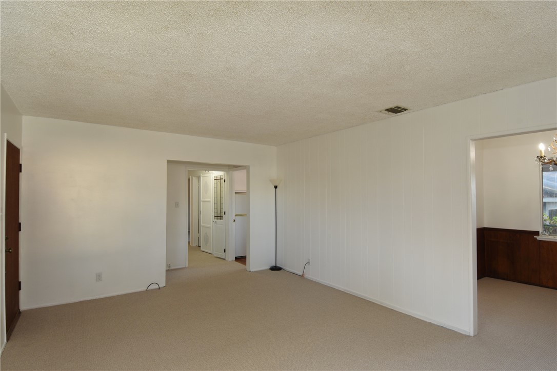 Another living room shot (entry door on the left), dining room on the far right.