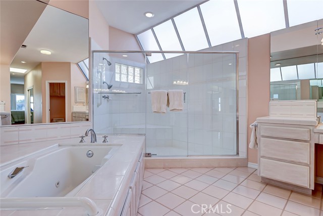 Primary Bath view of relaxing bathtub and huge glass walk-in shower