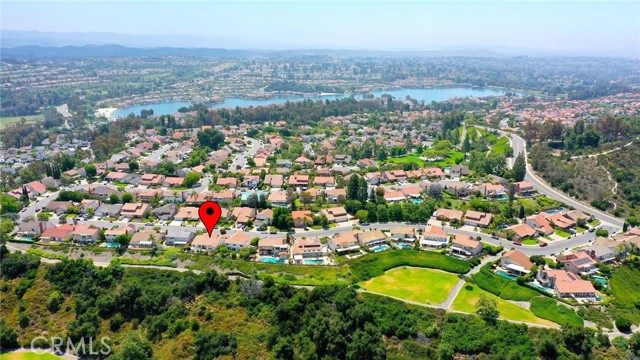 Just a stone's throw from the sparkling waters of Lake Mission Viejo, this home offers quick and easy access to a quiet greenbelt and nearby Minaya Park. Imagine being able to stroll over in mere seconds to enjoy the lush greenery and outdoor fun! The lake is less than five minutes away.