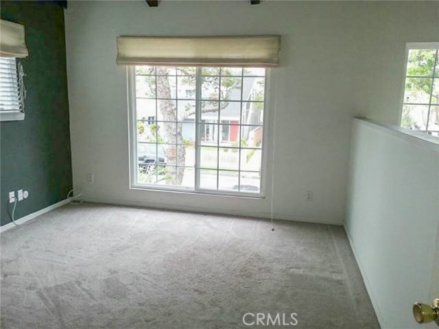 The quite large loft at the front of the unit with a wall on the left overlooking the living room.