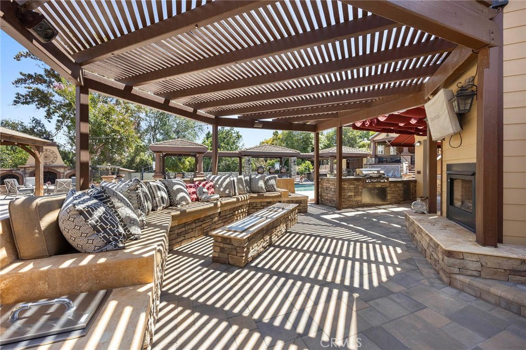 Huge built in stone bench with double fire pits, and built in beverage coolers.