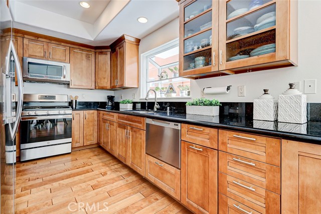 Warm wood cabinets, gleaming granite counters, stainless steel appliances.