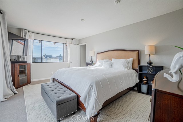 The larger primary suite is bright and spacious featuring a balcony, large customized walk-in closet, and an ensuite bathroom with dual sinks and large spa-like shower.