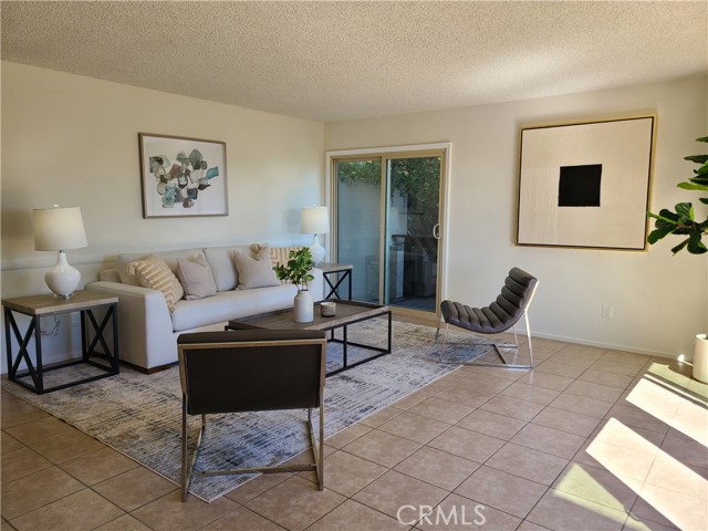 Spacious Family Room off Kitchen to the other side.  Small balcony off in the distance, large balcony to the right