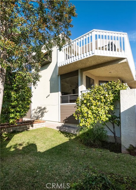 View of #5 from rear of site.  Upper level is deck off living area. Master bedroom is just below...MB deck is not visible behind foliage