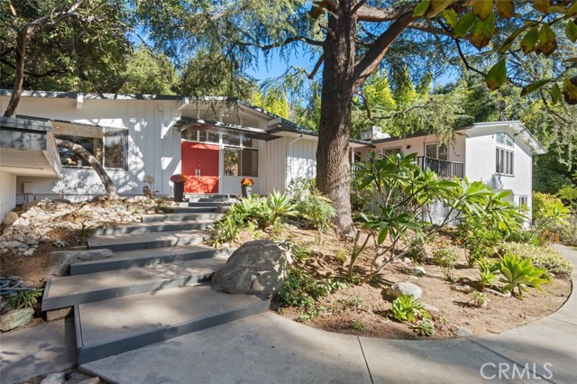 Rare opportunity to acquire this beautiful mid-century contemporary estate, one of few designed by noted architect Arthur Swab in the prestigious and gated area of North Kinneloa Ranch, in Pasadena.
Situated on a sizable acre plus of use-able and verdant grounds offering open floor plan, stunning living room with vaulted ceilings and walls of glass allowing seamless integration with nature and surrounded by estates mostly sitting  on acre plus of land which ensures utmost privacy.
Six bedrooms (can be 7, 2 were combined) 5 baths. Upstairs is a generous primary bedroom with large walk-in closets, a second en suite bedroom completes the upstairs.  Downstairs featuring 4 bedrooms, 2 baths, built in linen cabinets and a laundry room with access door to backyard.  This home is Tri Level with very few steps leading to upstairs and downstairs, multiple patios and three beautiful fireplaces, dual HVAC, two car detached garage, park like grounds with pool, spa, fruit trees, large storage shed and all the serenity and tranquility one can ask for, ideal for live and work from home.