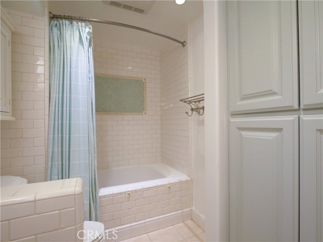 Bathtub/shower and storage closets (ensuite to guest room 2)