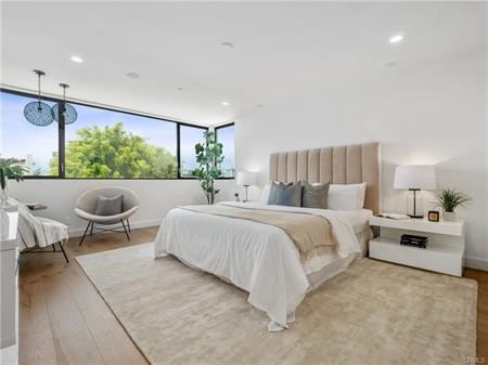 Primary bedroom. West facing windows that brings light into the room.