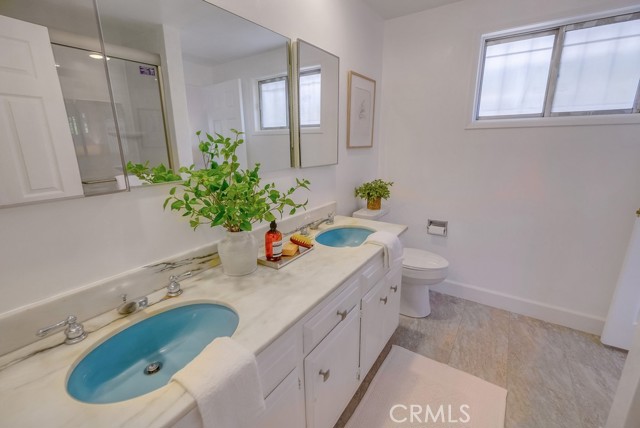 Main bathroom off hallway with dual vanity