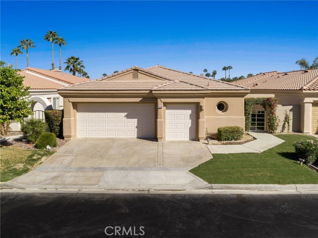 55030 Tanglewood La Quinta, California A bright and breezy PGA West Mediterranean style home boasts a great room with a highlighted by a stacked stone fireplace, media viewing, formal dining, and a breakfast nook. Kitchen boasts dual ovens and granite counter tops. Enter the foyer and continue to the bar area with stools and a seated conversation space. A large master suite includes a large shower, soaking tub and a small workout space. There are two additional bedrooms, one of which can be used as an office or playroom. One bedroom is en-suite with a separate entry. Once through the house, exit through the large sliders to the covered patio, with outdoor furniture, and private pool and spa (built in 2020). This is the perfect place to enjoy the golf course and mountain views. The home has a large two car garage and an additional space to park your golf cart. The house is across the street to an additional lakeside gated community pool and spa.