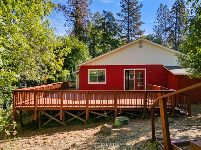 Back of apartment with large deck over looking Kelsey Creek