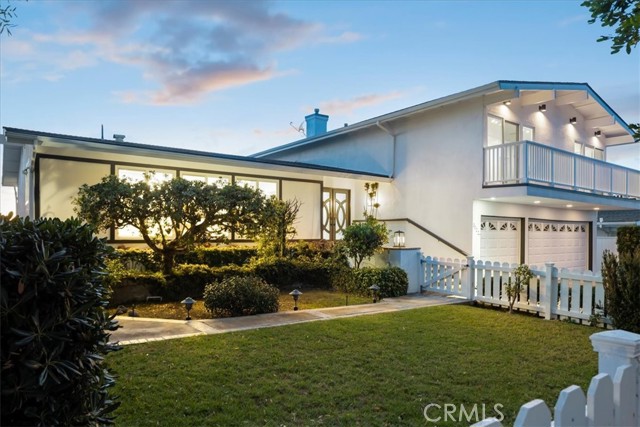 front yard enclosed by white picket fence