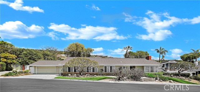 Welcome to your dream home! This stunning single story mid-century home boasts breathtaking views of the ocean and sunsets, providing a serene and tranquil backdrop to your life. Tucked away in a cul-de-sac in the sought-after Monarch Bay gated community, this home offers the perfect blend of privacy and luxury.   As you step inside, you'll be greeted by an original interior featuring herringbone wood floors and bright, voluminous living areas with exposed wood beam vaulted ceilings. The living, dining, and kitchen are perfect for hosting family and friends.  Step outside onto the expansive private patio with a hot tub, putting green, and a rock waterfall, where you can enjoy endless hours of relaxation and entertainment. If you're feeling more active, Monarch Bay has many amenities, including a beachfront club, lighted tennis courts, pickleball courts, volleyball, basketball, spa facility, a clubhouse, and an indoor gym.  The Monarch Bay Community offers the luxury of 5-star resorts including the Montage, Ritz Carlton, and Waldorf Astoria, while Monarch Beach's renowned walkability ensures easy access to pristine beaches, fine dining, golf courses, tennis courts, hiking trails, and the bustling Dana Point Harbor. The Monarch Bay Private Beach Club stands as a rare gem, offering exclusive access to the sandy shores—a privilege reserved for residents of this exceptional enclave. Embrace the unparalleled lifestyle of Monarch Bay, where every day feels like a vacation in paradise. Don't miss the opportunity to make this single-level haven your own and experience the ultimate in coastal living.