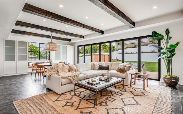 844 10th Street Manhattan Beach, California Embrace everything that LA has to offer every time you’re greeted by the cinematic view of downtown from your chic Hill Section home. This 2020 transformation gives you a Modern Beach Montecito home with organic elements to make it both current & comfortable all with excellent access to all MB & LA have to offer. Just blocks from the beach, downtown MB & award-winning Robinson Elementary, this open, 4,500 SF floor plan, includes 5 stylish en-suite bedrooms and is filled to the brim with natural light. The dramatic formal entry is flanked by a vaulted, inviting living room and an elegant, elevated dining space. Down the hall you’ll find your private office, and beyond lies the gorgeously-lit modern island kitchen and open family room with beamed ceilings and fireplace. A massive sliding glass wall creates a refreshing indoor/outdoor gathering space that includes the family room, patio and lush private yard. Host overnight guests on this floor in a private bedroom with en-suite bath, or use this space as an elegant study. Upstairs, a wide hallway leads to a generously-sized laundry room, 3 more ensuite bedrooms… and the jaw-dropping owner’s suite. This light-filled enclave – the very embodiment of luxury – features a sitting area with fireplace, private balcony & a vaulted, showcase bathroom with elegant soaking tub, two-person shower and adjacent studio-apartment-sized walk-in closet. 844 10th Street is more than a home; it’s an everyday escape for the most discerning buyers.