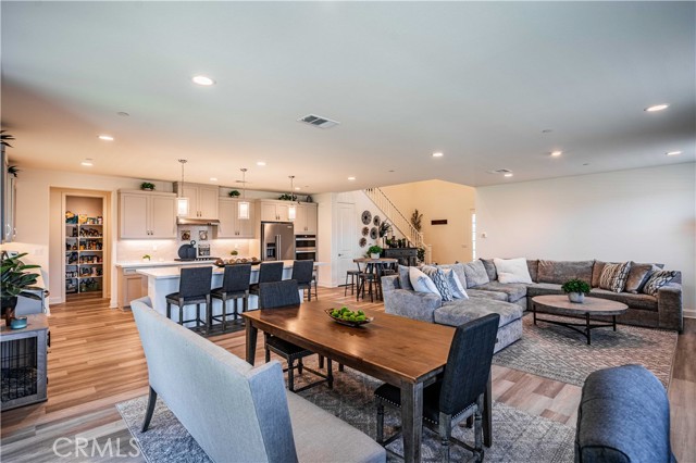 The great room is spectacular! Cozy family room opens to your stunning quartz contertop kitchen. Wood laminate flooring, recessed lighting. Walk in pantry is the door on the right, past the butlers pantry.