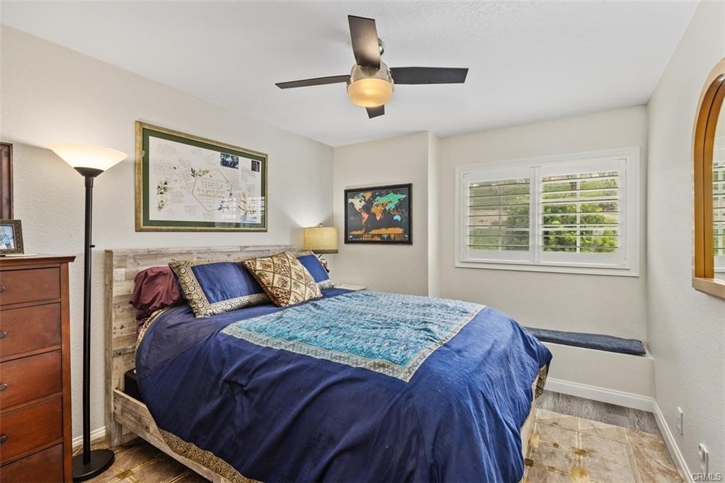 Secondary bedrooms are spacious and have custom shutters and ceiling fans.