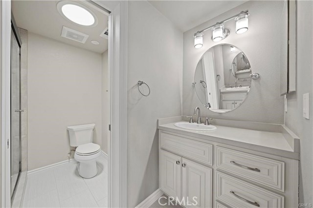 Mirror image of the dual vanities. The skylight floods the master bathroom with ample natural lighting.
