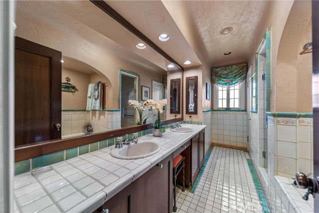 Beautifully tiled remodeled hall bath with separate tub and shower