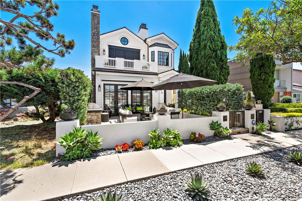 Tucked away in a coveted nook of the Village, this exquisite 2-bedroom home exudes luxury and was masterfully crafted by renowned builders, Patterson Custom Homes, epitomizing quality craftsmanship, timeless design, and impressive interiors.The home has been impeccably maintained as part of the Patterson Custom Homes "Customer Care Program", and there is an option to extend this premier service. The great room boasts soaring ceilings, bathing the space in natural light, while the living room features walls of glass that lead to an alfresco loggia with a cozy fireplace—an ideal spot for relaxation. The chef’s kitchen supplies top-of-the-line appliances, expansive counters, ample cabinetry, and a breakfast bar overlooking the elegant dining room. The main floor primary bedroom is a serene retreat, offering a spacious walk-in closet and a spa-like bathroom complete with a walk-in shower, soaking tub, and dual sink vanity. The ensuite secondary bedroom is equally alluring, providing generous storage and easy access to the sprawling rooftop deck, which treats you to views of the city and the shimmering coastline. The home also includes a single-car garage with a storage room, epoxy flooring, and a single carport for added convenience. Conveniently located within a short distance to CDM beaches and the charming boutiques and eateries of Corona Del Mar, this home is the epitome of coastal living—a perfect oasis for those seeking an upscale and relaxing lifestyle.