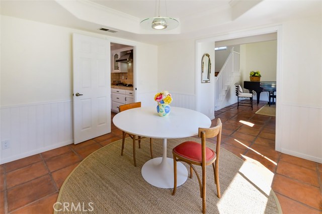 Another view of the dining room showing the kitchen to the left and the formal living room to the right.