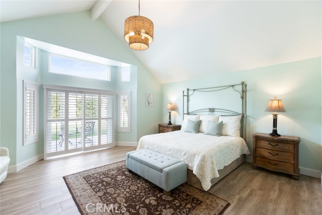 The primary bedroom looks out over the backyard and has direct access to the patio area. You will love the beautiful windows and nice high ceilings.