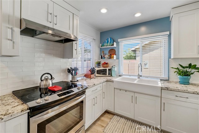 Kitchen & Eating area. Upgraded flooring. New Kitchen Cabinets, granite countertops, New Sink, New Stainless steel dishwasher,  stove, abd range. recessed lighting, cordless blinds